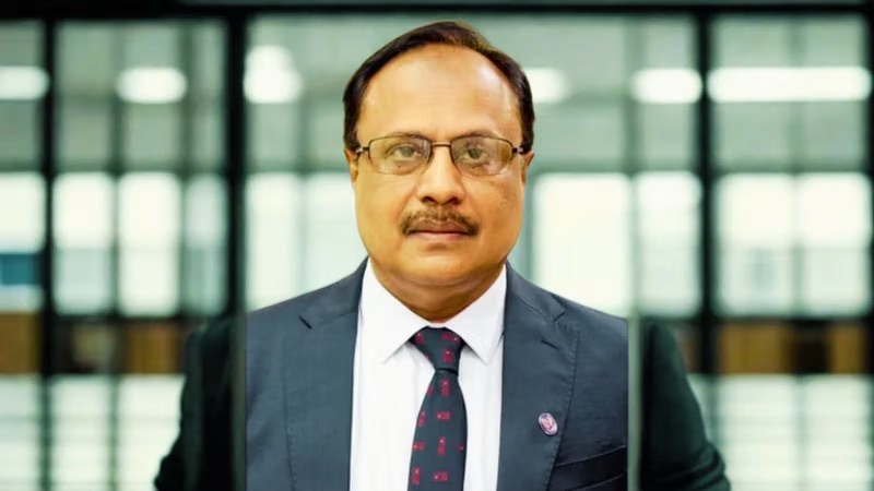 Ramakrishnan Chander in a dark suit and tie, photographed in an office interior with a glazed wall behind him.